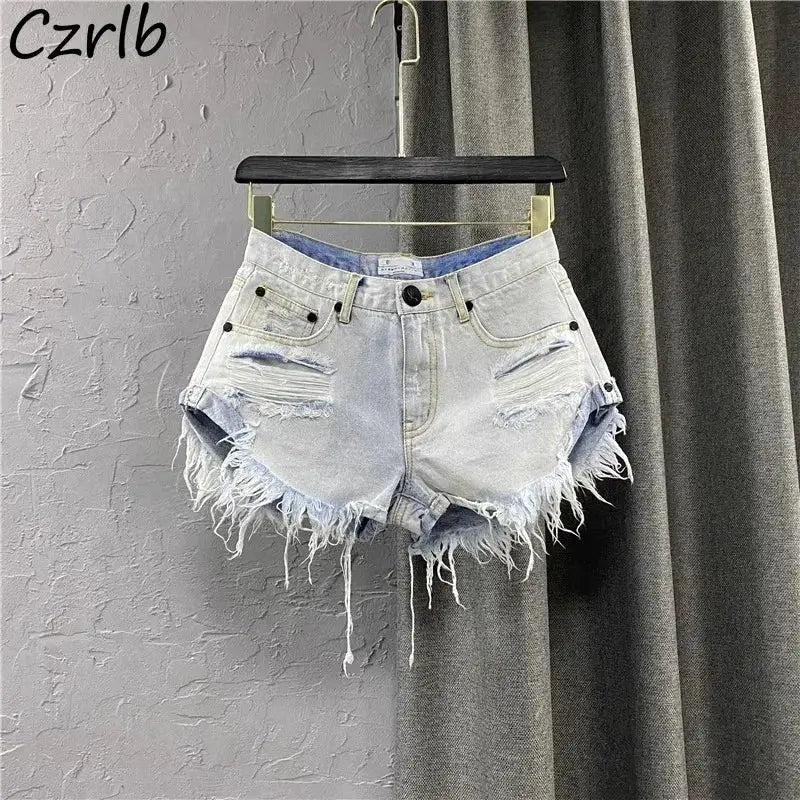Women’s denim shorts by Simples Market, light blue distressed with frayed irregular hems for casual streetwear.