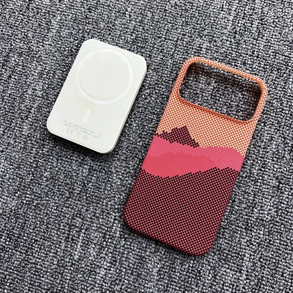 Phone accessories: white MagSafe charger pad and Simples Market frameless carbon fiber Kevlar MagSafe case with texture.