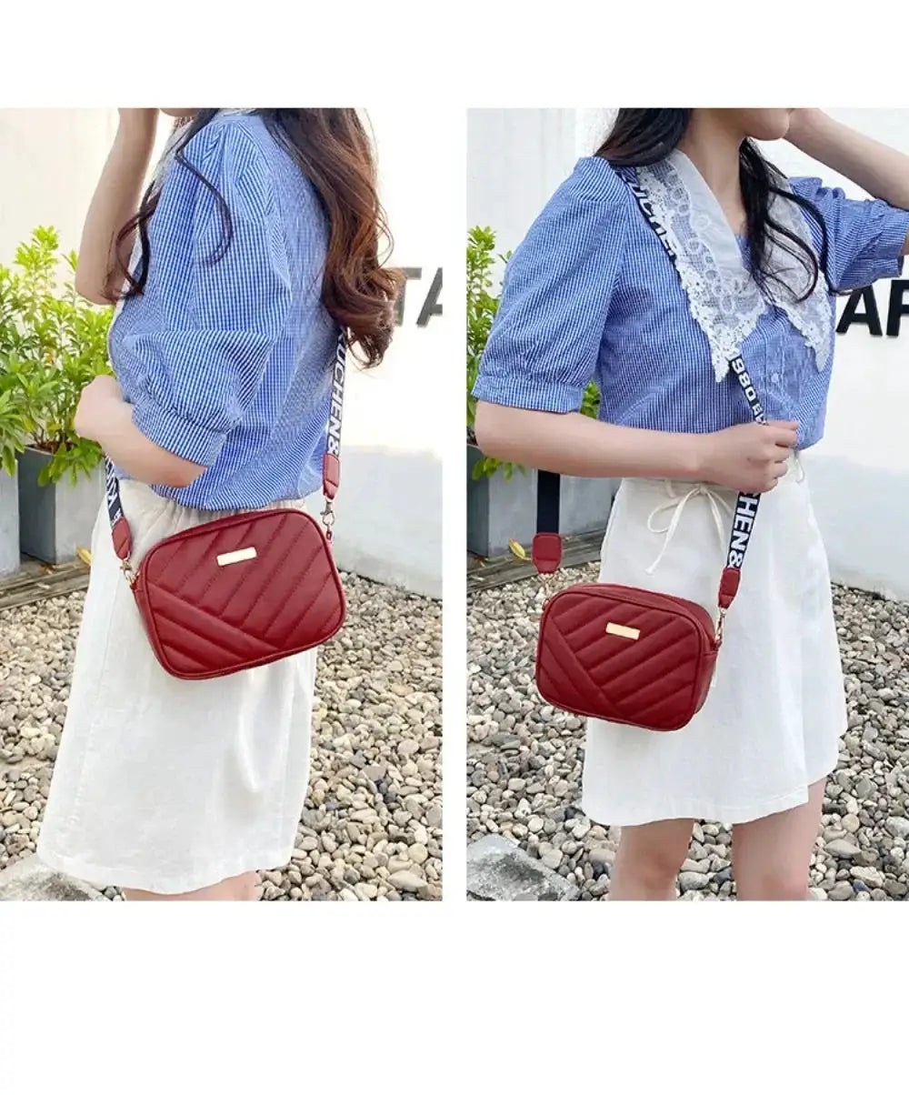 Red quilted PU shoulder bag with diagonal stitching and a gold plaque, worn as a crossbody