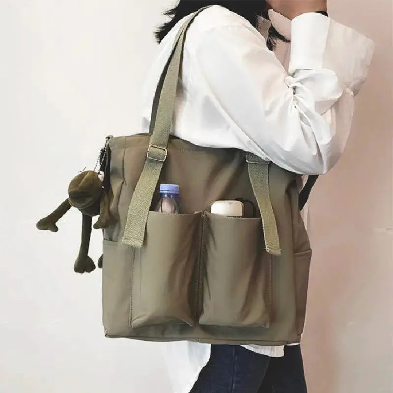 Simples Market waterproof Oxford women's handbag, olive green, large-capacity shoulder crossbody with front pockets.