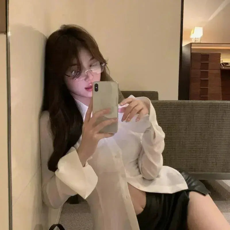 White women's blouse with flared sleeves, lapel collar and front buttons