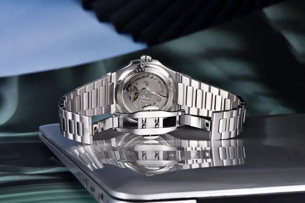 PAGANI DESIGN men's skeleton automatic watch in stainless steel with silver bracelet and transparent case back.