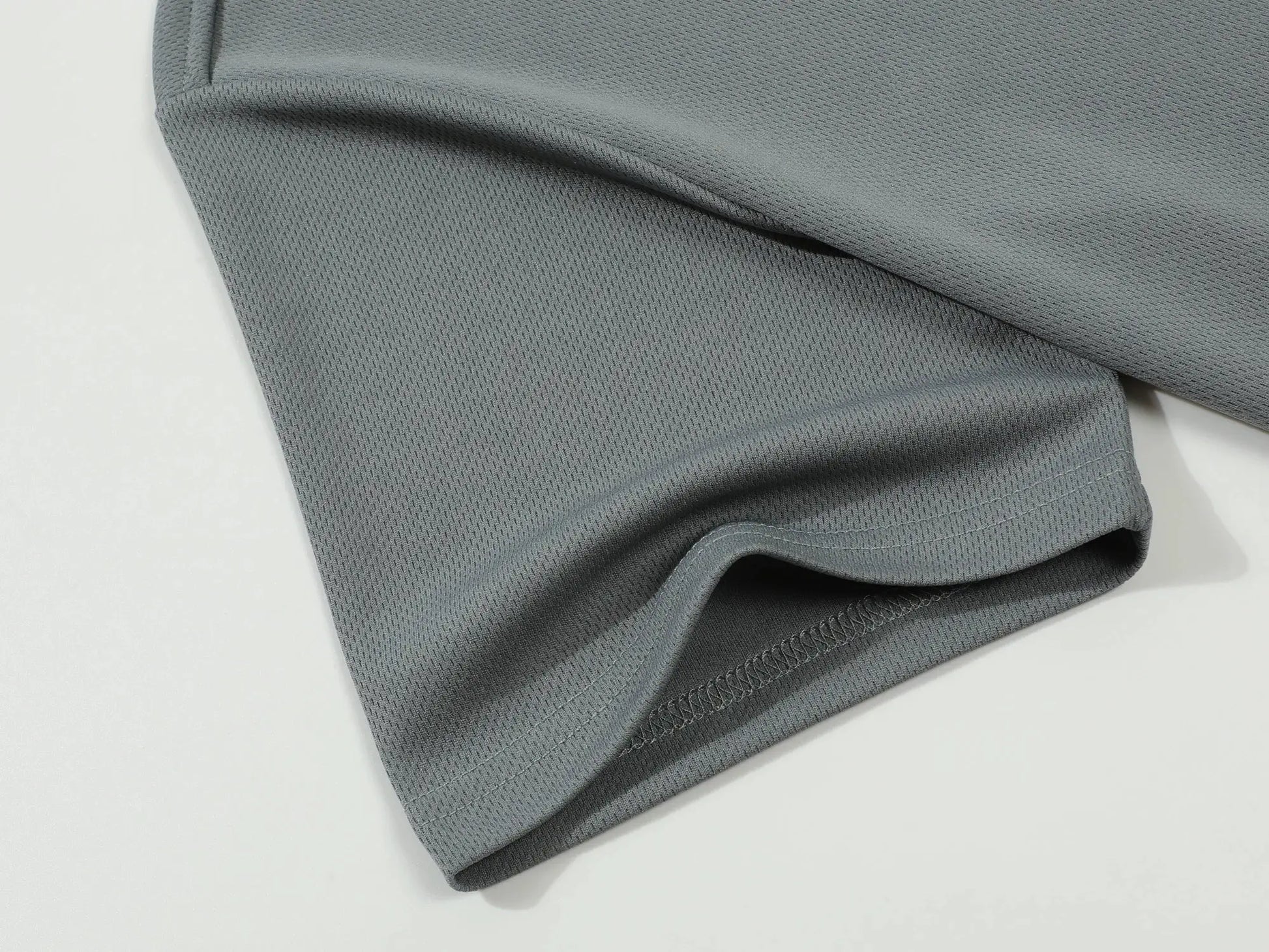Polo shirt fabric close-up in gray; textured knit, breathable, Simples Market.