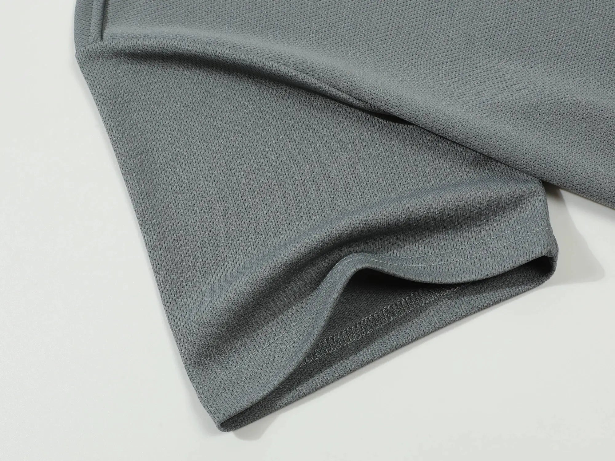 Polo shirt fabric close-up in gray; textured knit, breathable, Simples Market.