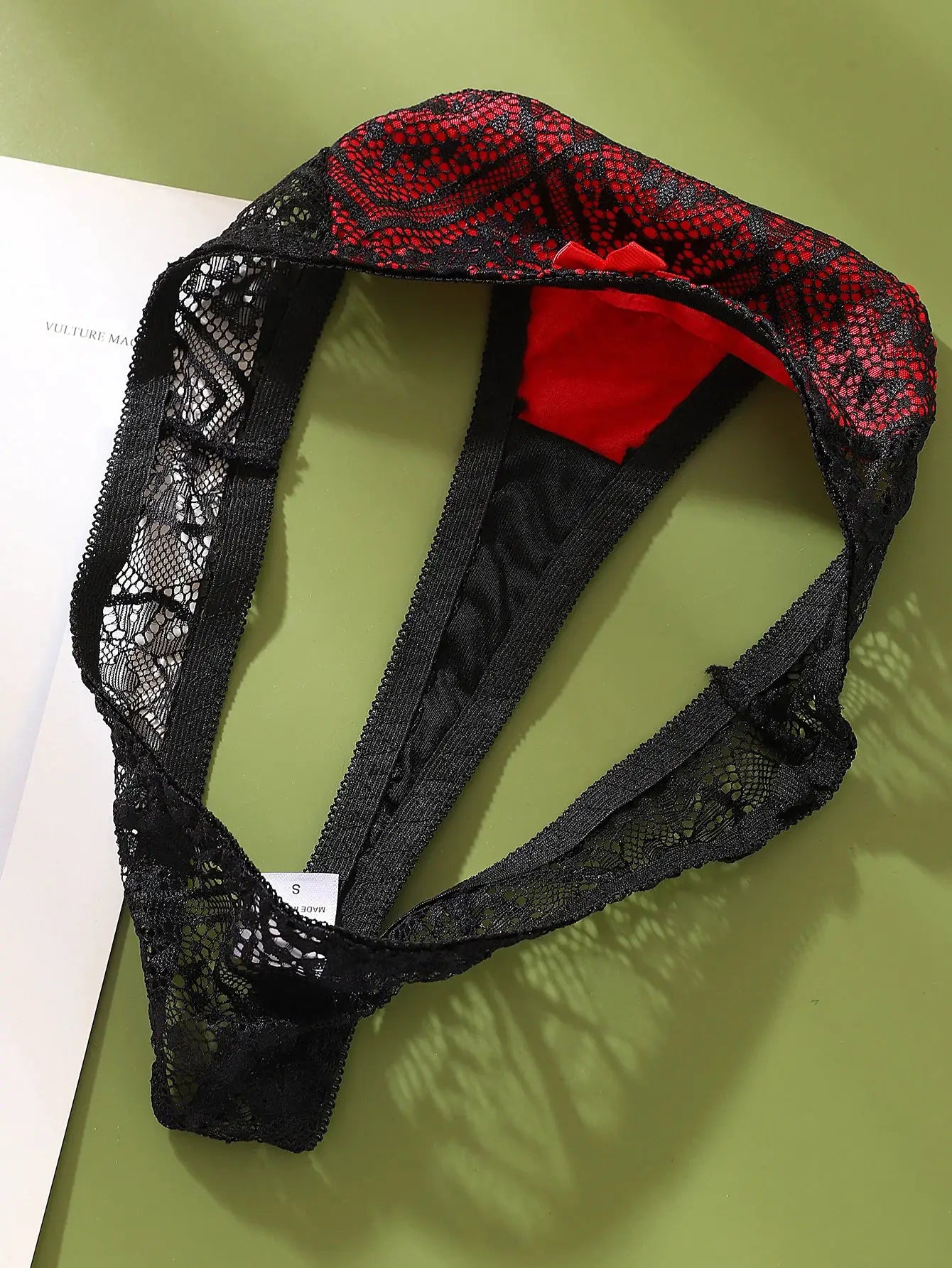 Black lace G-string thong with red satin lining and small red bow