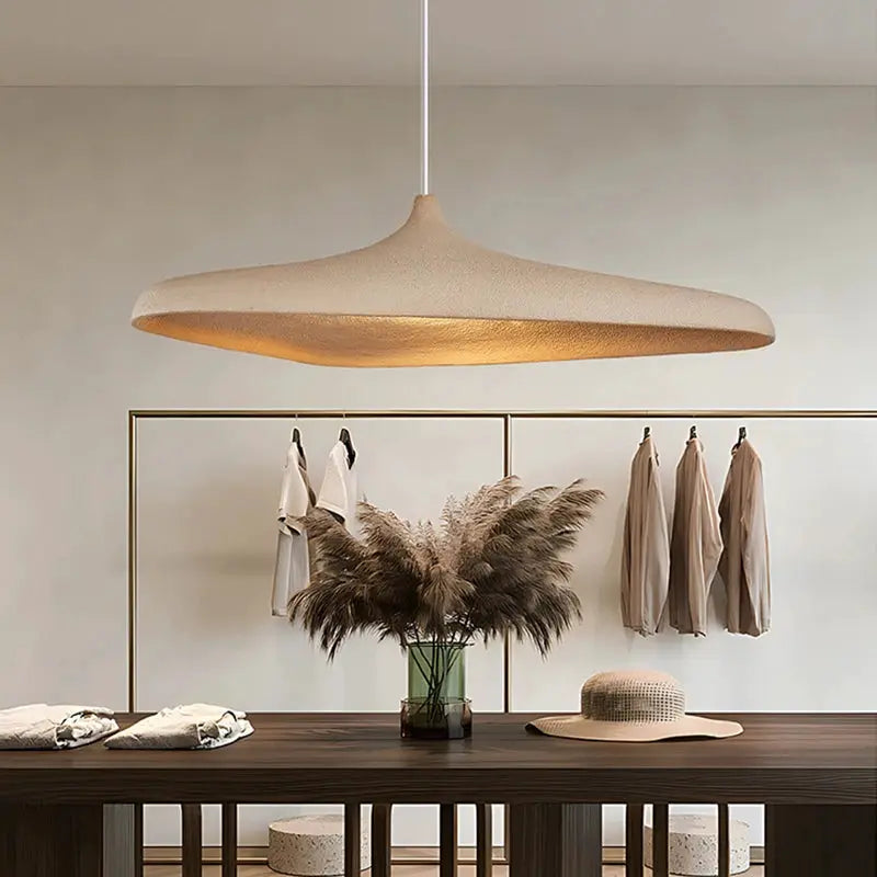 Japanese Wabi Sabi style LED pendant light with a cream curved shade hanging over a wooden dining table.