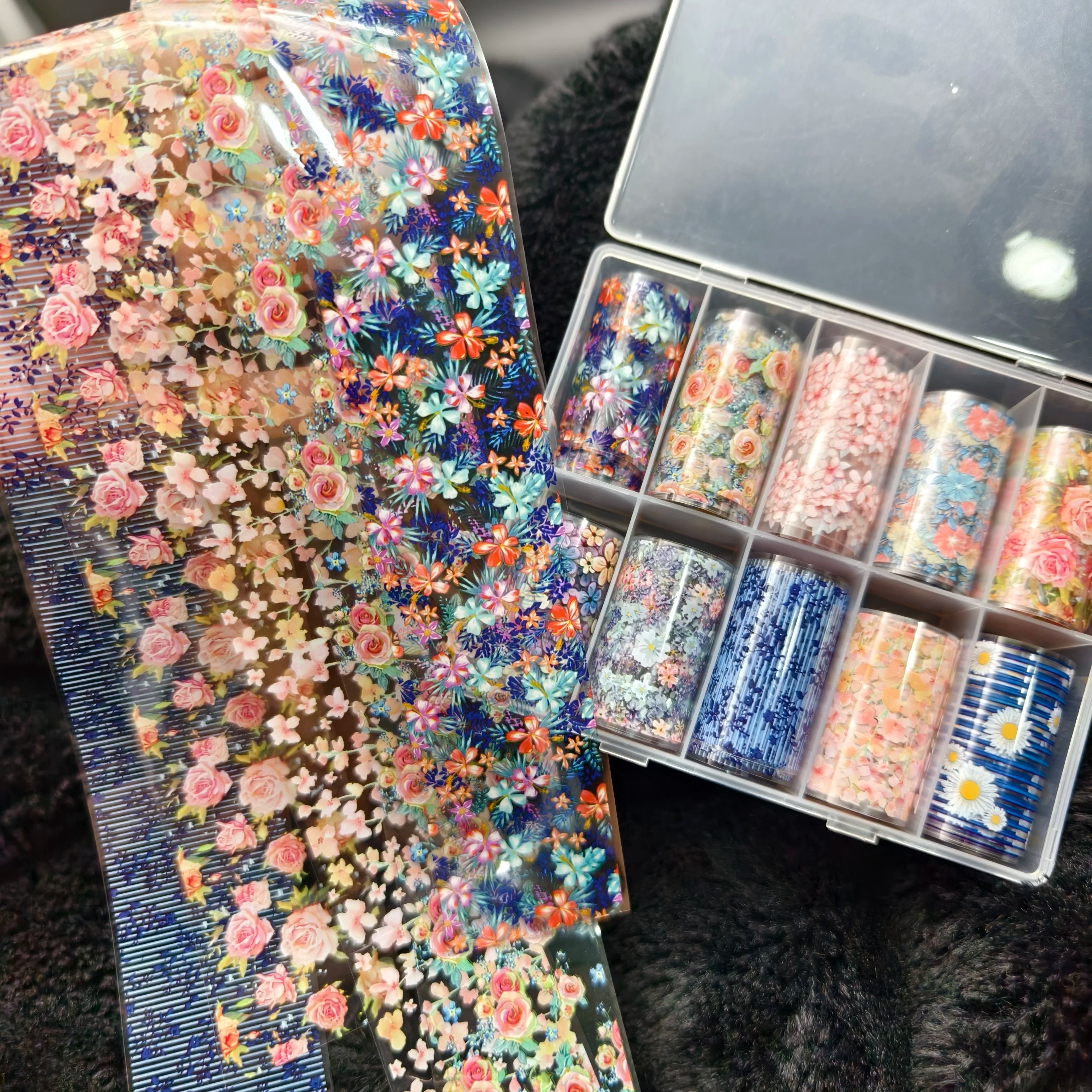 Nail art foils by Simples Market, 10 rolls of floral decal sheets in pink, blue, orange.