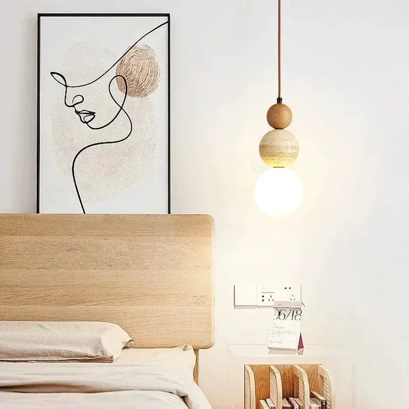 Cream style pendant lamp by Simples Market; wood bead accent with LED bulb over a bedside table.