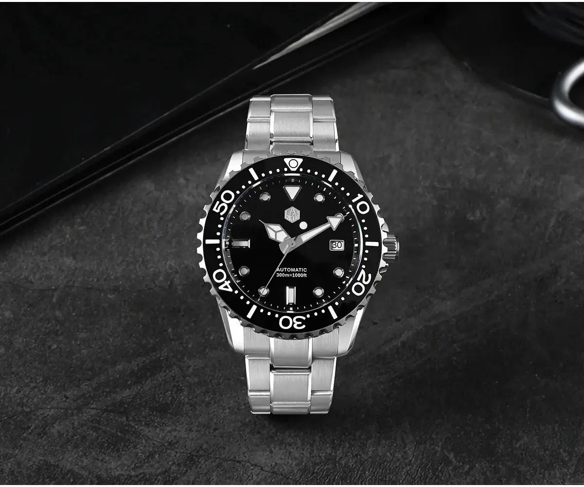 San Martin diver watch with stainless steel bracelet, black dial, and rotating bezel.
