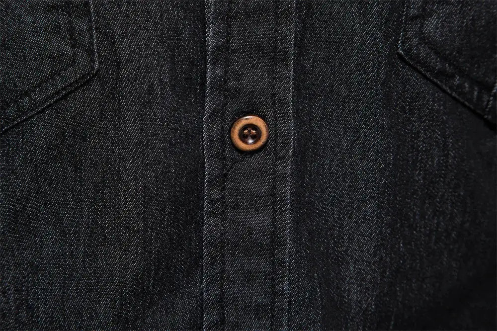 Denim shirt close-up in dark wash cotton denim with brown button detail