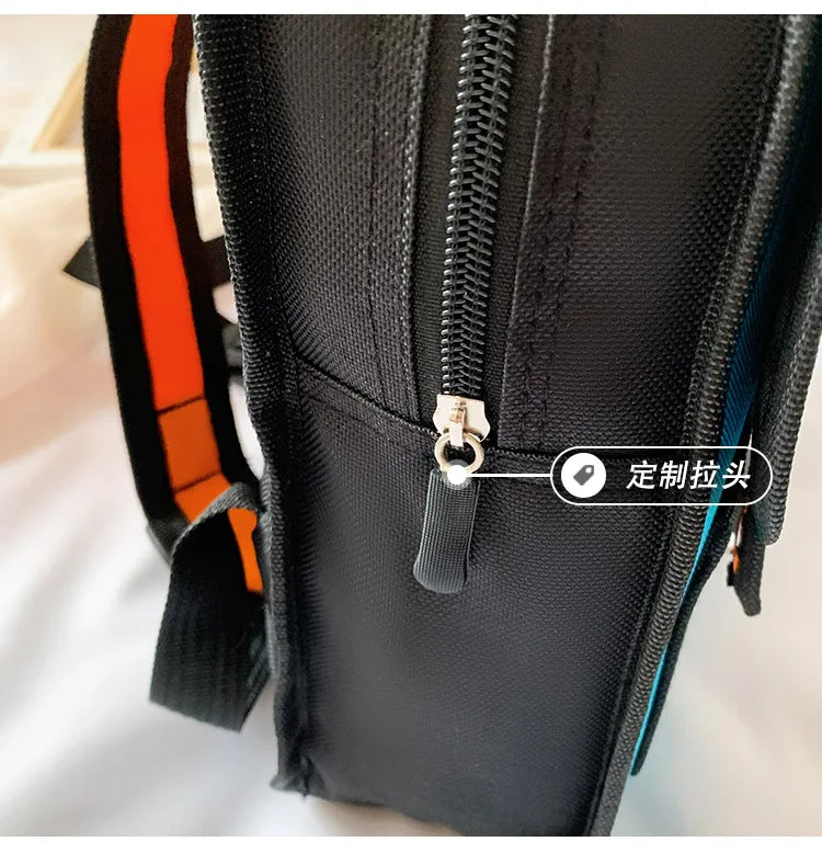 Two-Dimensional 3D multi-functional school backpack for children; black with orange accents and zipper pull