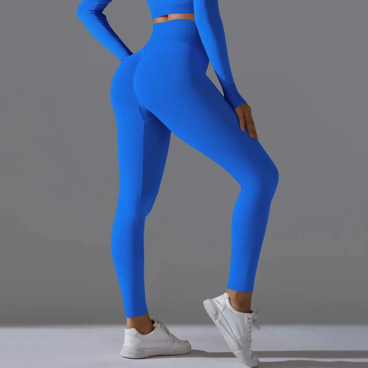 Women's seamless yoga leggings in electric blue with high-waist tummy control and scrunch butt.