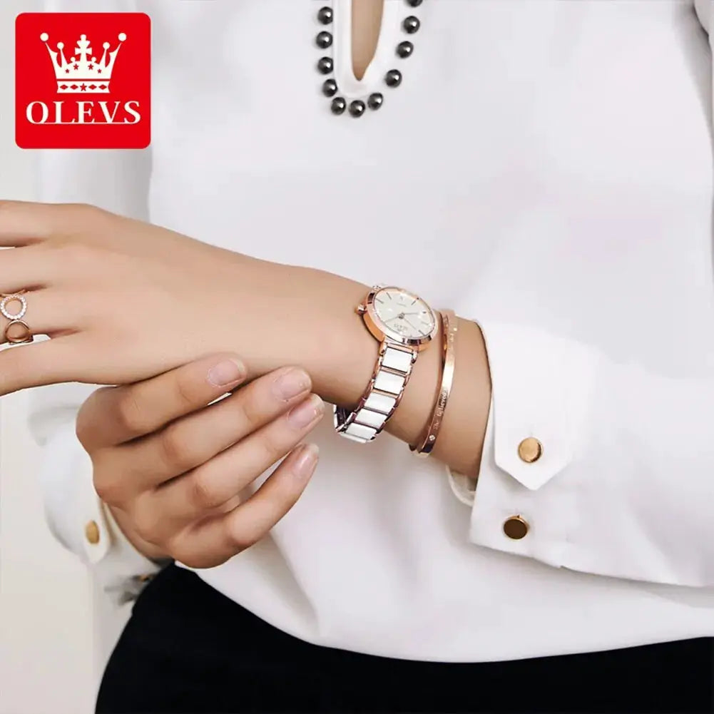 OLEVS women's rose-gold quartz watch with ceramic white strap and two bracelets on the wrist