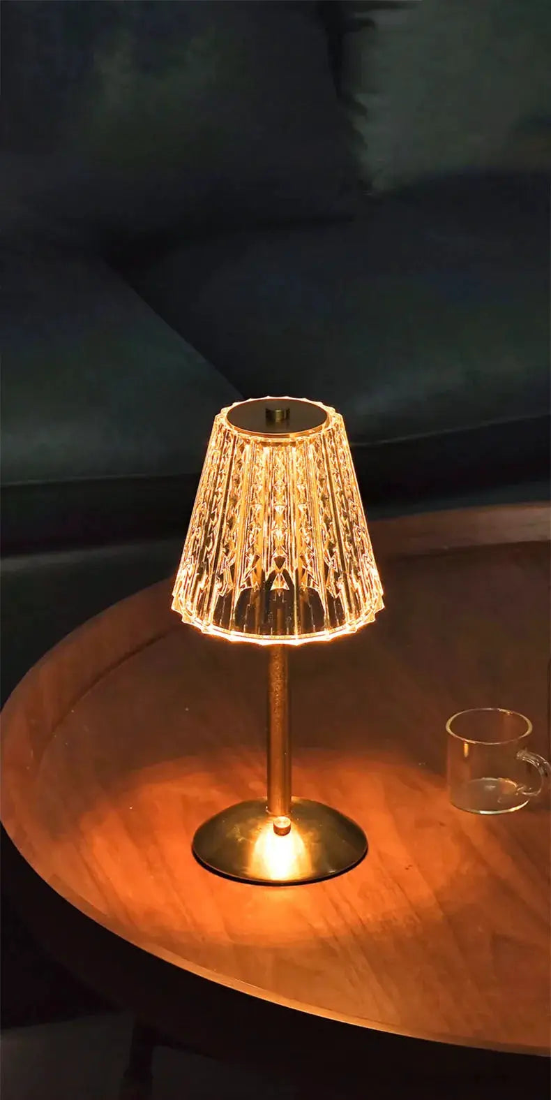 Crystal retro table lamp by Simples Market with amber LED glow and brass base on a wooden table