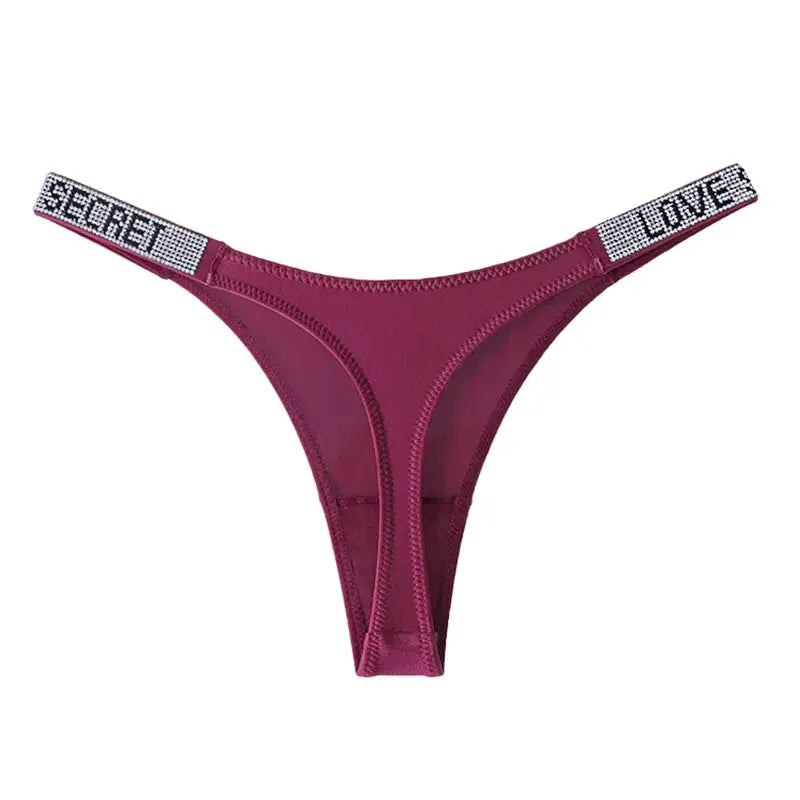 Thong by Simples Market in burgundy with rhinestone side straps and lettered text