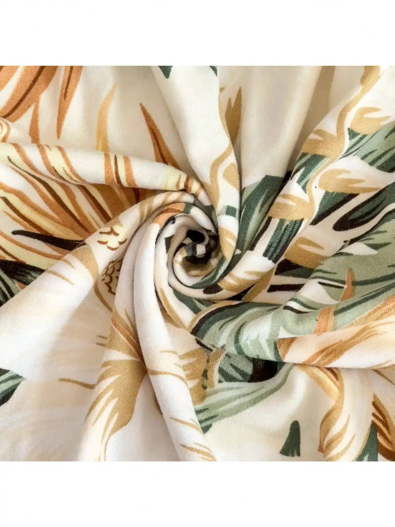 Outdoor tropical print sofa cushion cover with green and tan leaf pattern.