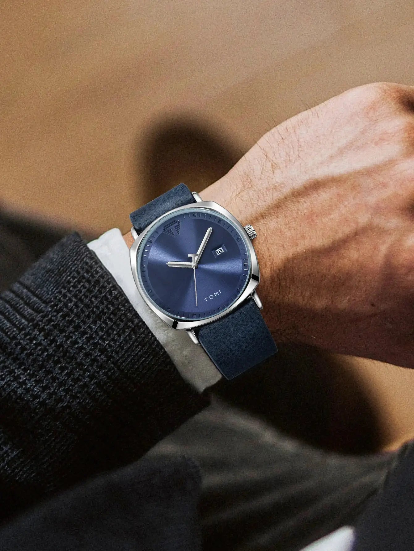 TOMI men's minimalist quartz watch with blue dial, calendar date window, and blue leather strap