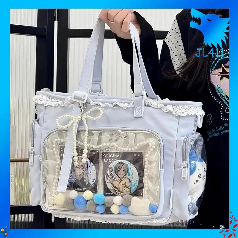 Ballet Girl itabag pastel lilac crossbody bag with lace trim and clear front pocket showing badges.