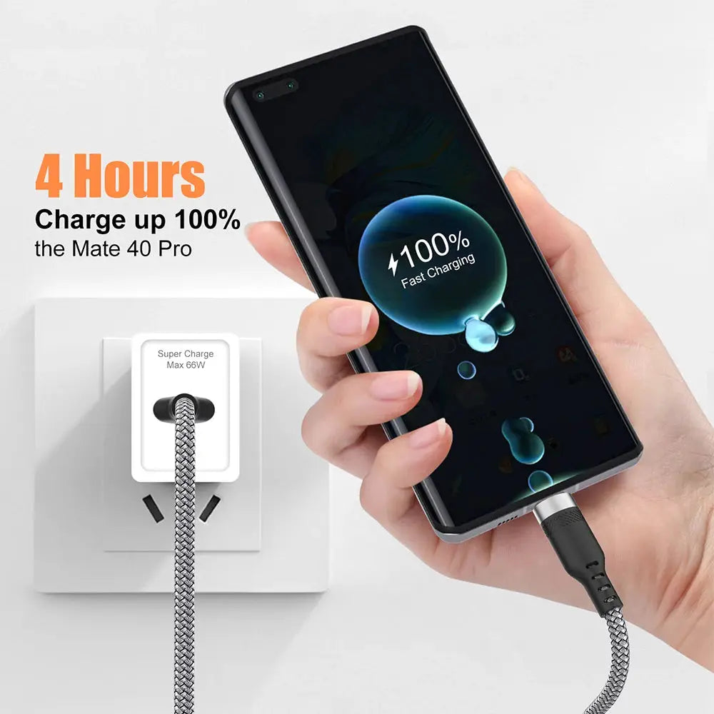 USB-C charging cable, braided silver metal exterior, connected to a wall charger powering a smartphone.