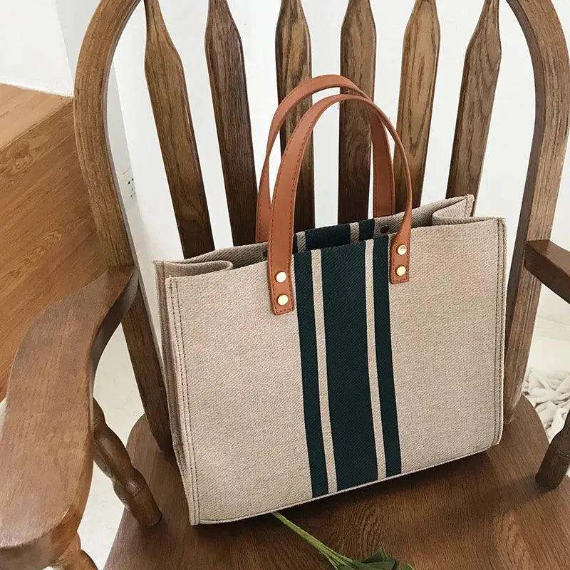Canvas stripe tote bag with brown leather handles; beige body, green stripe, large capacity