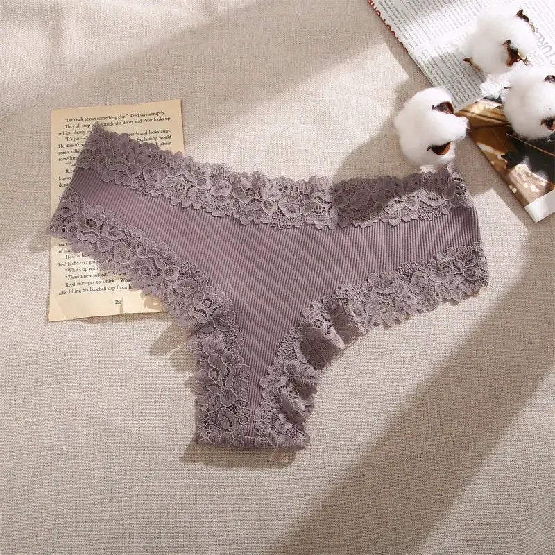 Women's lavender cotton panties with floral lace trim and ribbed fabric.