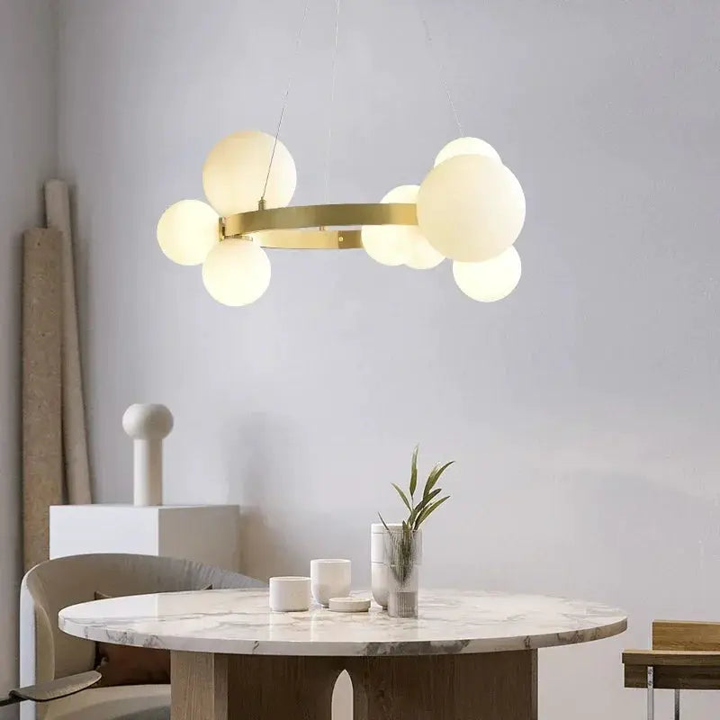 Simple Chandeliers Indoor Lighting by Simples Market, gold ring pendant with frosted white glass globes