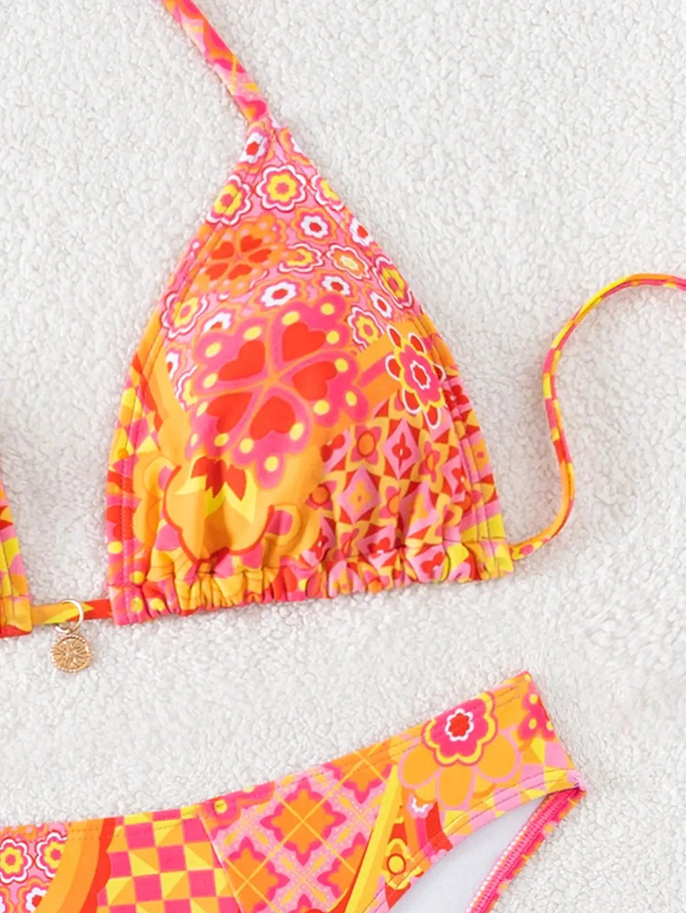Triangle bikini set by Simples Market in pink-orange floral print; push-up triangle top with Brazilian bottoms.