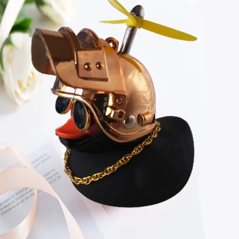 Rubber duck car ornament with copper helmet, yellow propeller, and gold chain