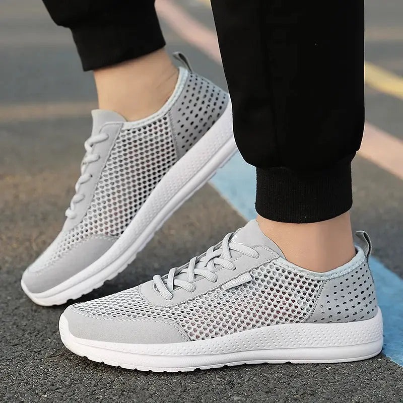 Men's breathable mesh sport shoes in light grey with a white sole, lightweight running sneakers