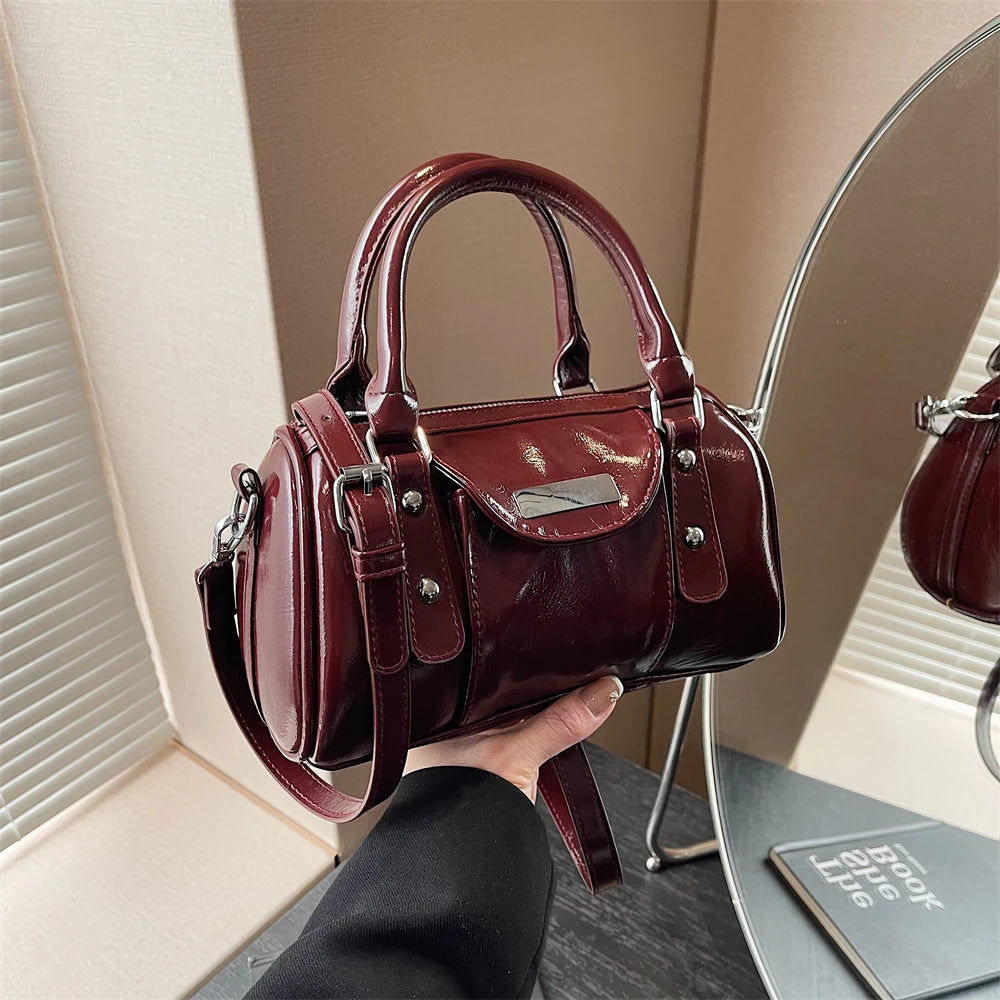 Mini burgundy top-handle bag by Simples Market in glossy PU leather with crossbody strap