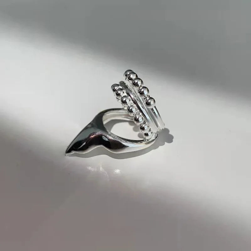 Silver elf ear clip earring with beaded circular cuff and curved wave detail