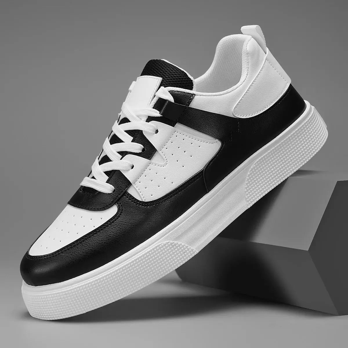 Men's casual sports shoes; lightweight black and white sneakers with a textured white sole