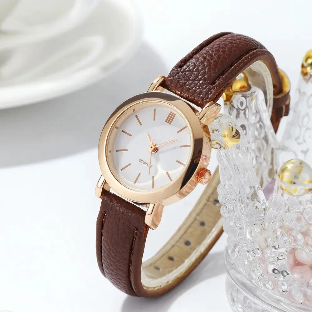 Women's wristwatch by Simples Market; rose-gold case, brown leather strap.