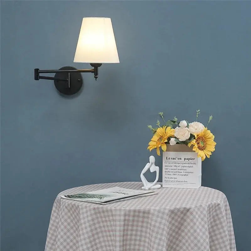 Nordic adjustable folding wall lamp with rotating rocker arm, black metal finish and white lampshade.