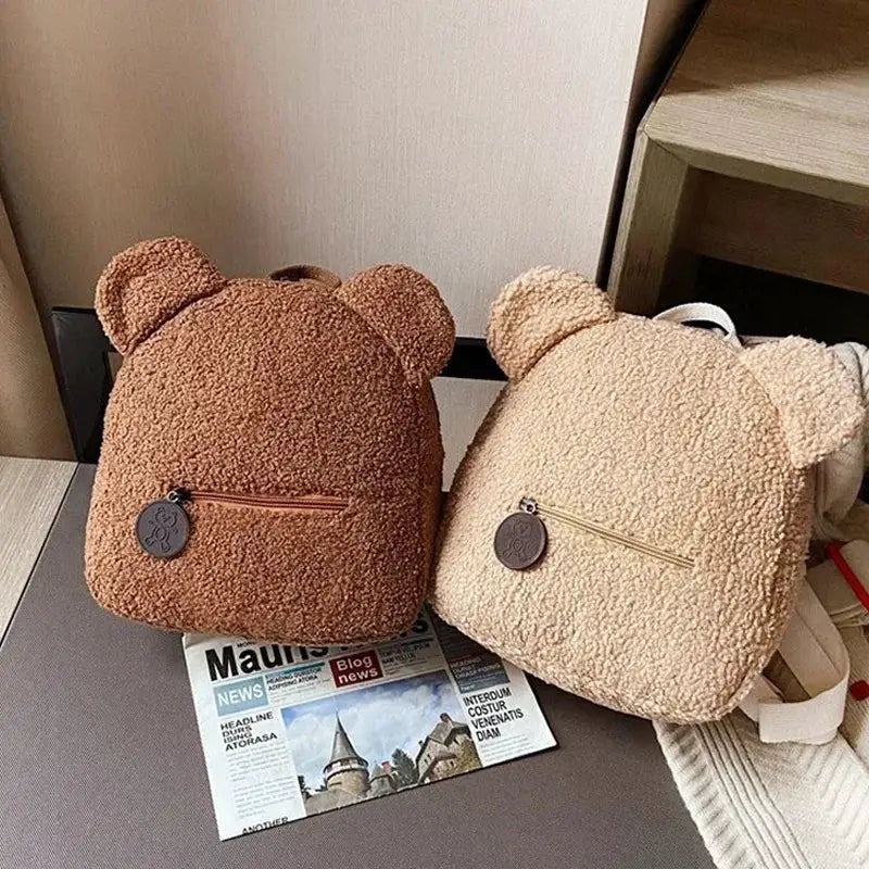 Two bear-ear fleece backpacks for kids, plush lambswool texture in brown and beige with front zip pockets