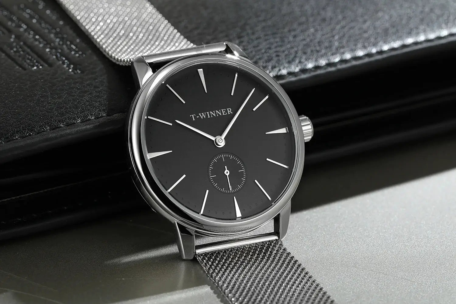 T-WINNER men's mechanical watch with black dial, silver case, and stainless steel mesh strap.