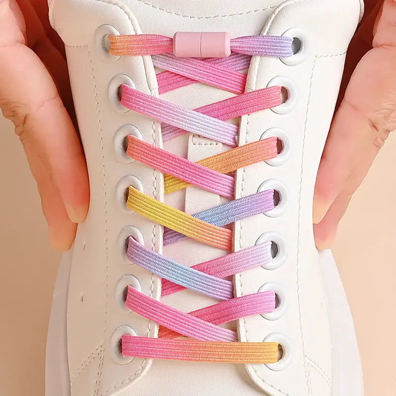 No-tie rainbow elastic shoelaces on a white sneaker, criss-cross lacing