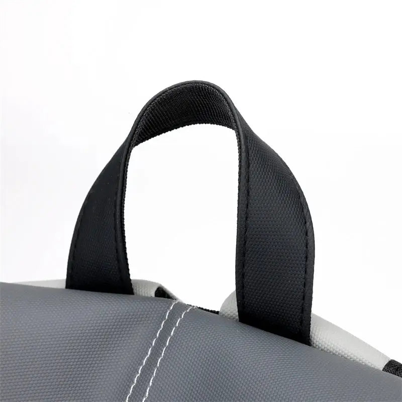 Backpack top handle close-up on gray waterproof laptop backpack