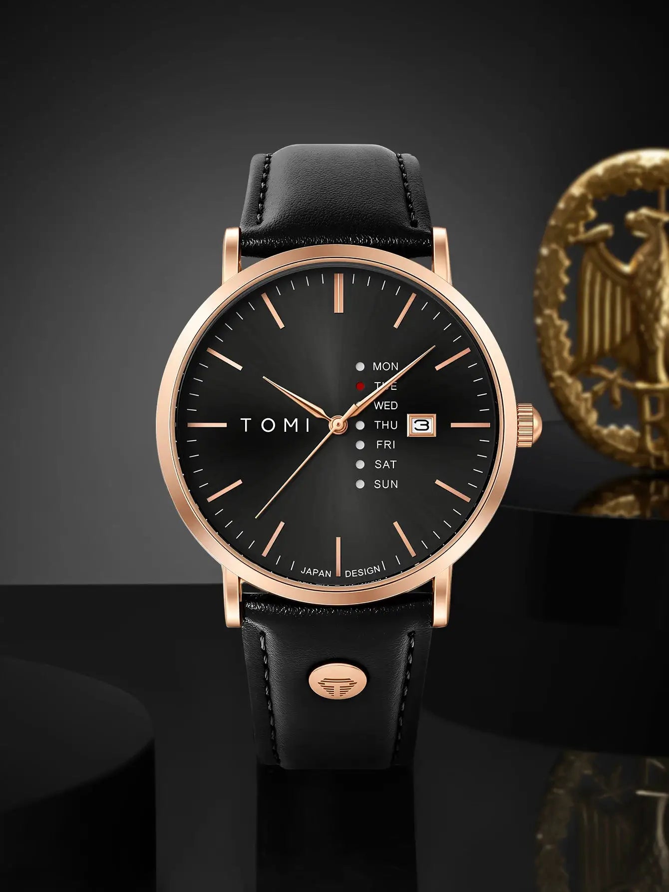 TOMI trendy men's quartz watch with black dial, rose-gold case, black leather strap and weekday calendar.