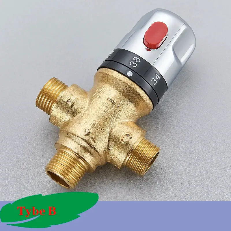 Brass thermostatic mixing valve by Simples Market with chrome control knob, red push button, and four ports