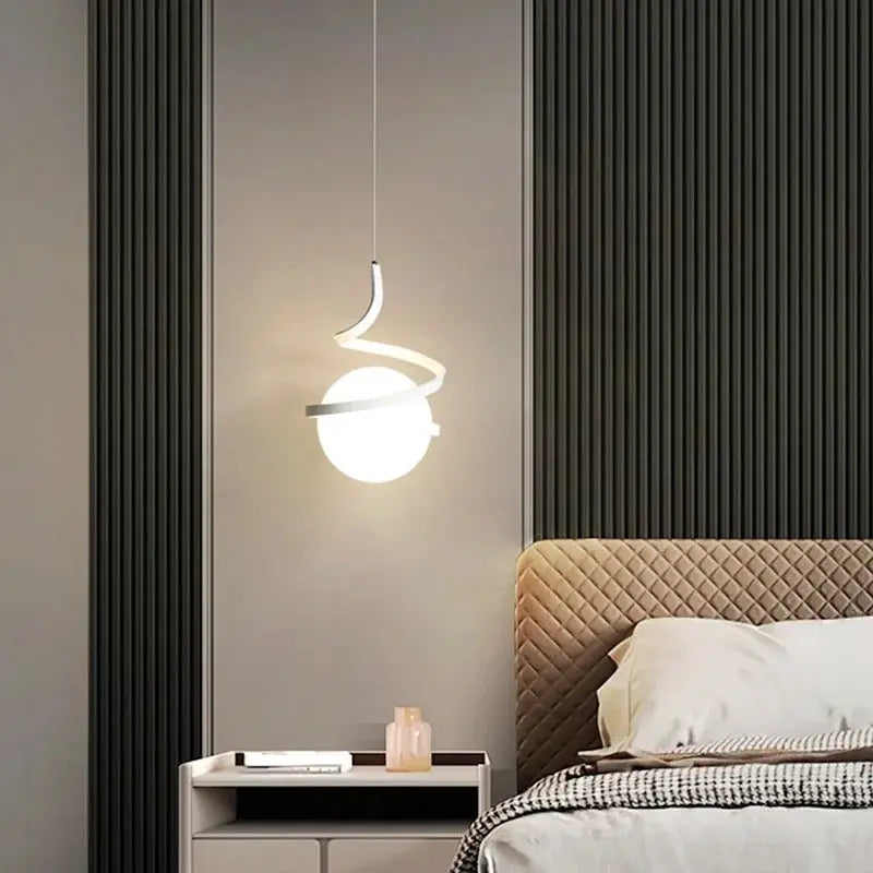 Nordic LED pendant light with a white globe and twisting arc, ideal as a bedroom bedside lamp.