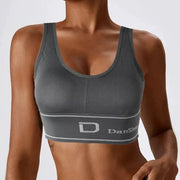 Women's gray seamless wireless sports bra with full-coverage design and DanShe logo on the wide band