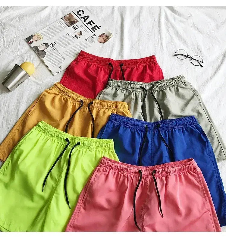 Men's swim shorts in eight colors arranged on a white background