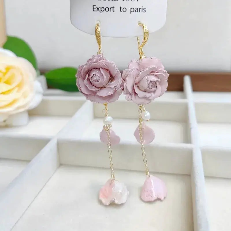 Elegant Immortal Rose Long Earrings with pale pink epoxy roses, gold hooks, pearl beads and dangling pink petal charms