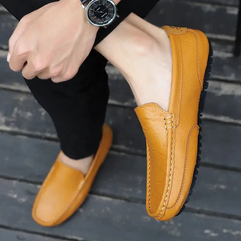 Pair of men's tan genuine leather loafers, breathable slip-on driving shoes.
