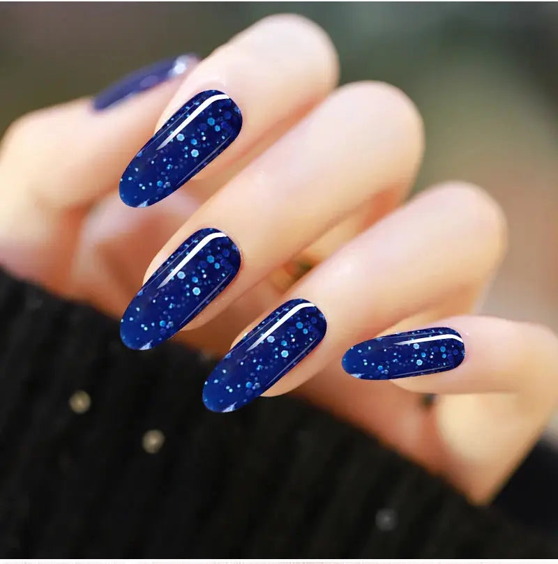 Nail gel manicure with blue glitter polish on almond-shaped nails