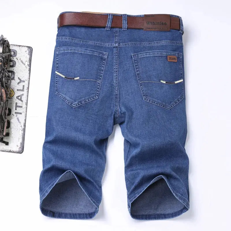 Men's blue denim shorts with belt, back pockets, and small leather patches for a classic casual look.
