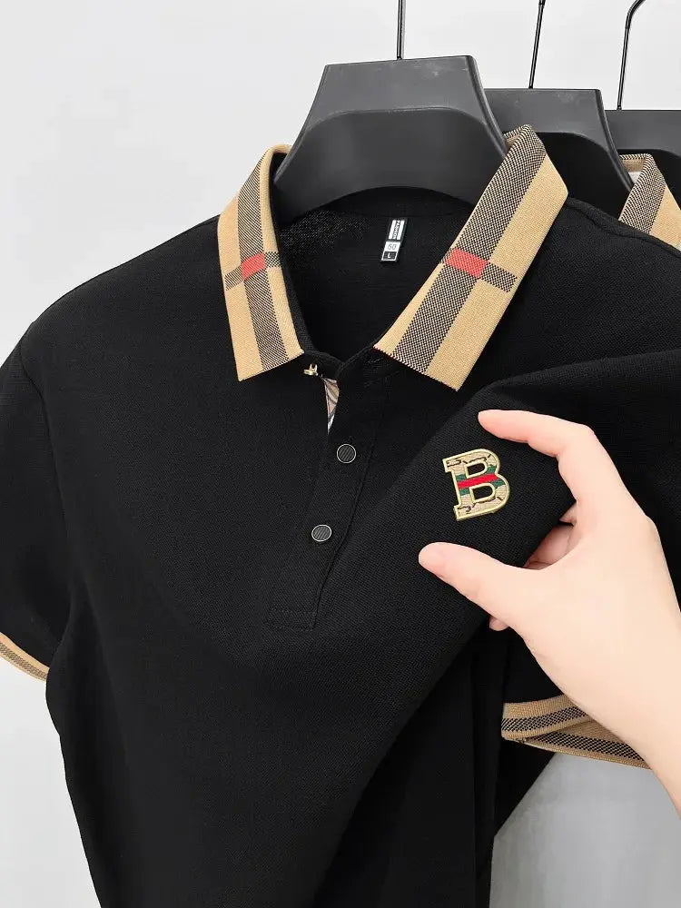 Men's black polo shirt with beige plaid collar and cuffs, embroidered B logo on chest.