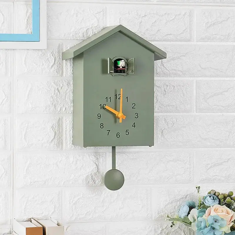 Cuckoo quartz wall clock, green, house-shaped with orange hands and pendulum