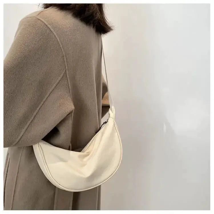 Nylon dumpling bag, cream color, compact crossbody with long strap